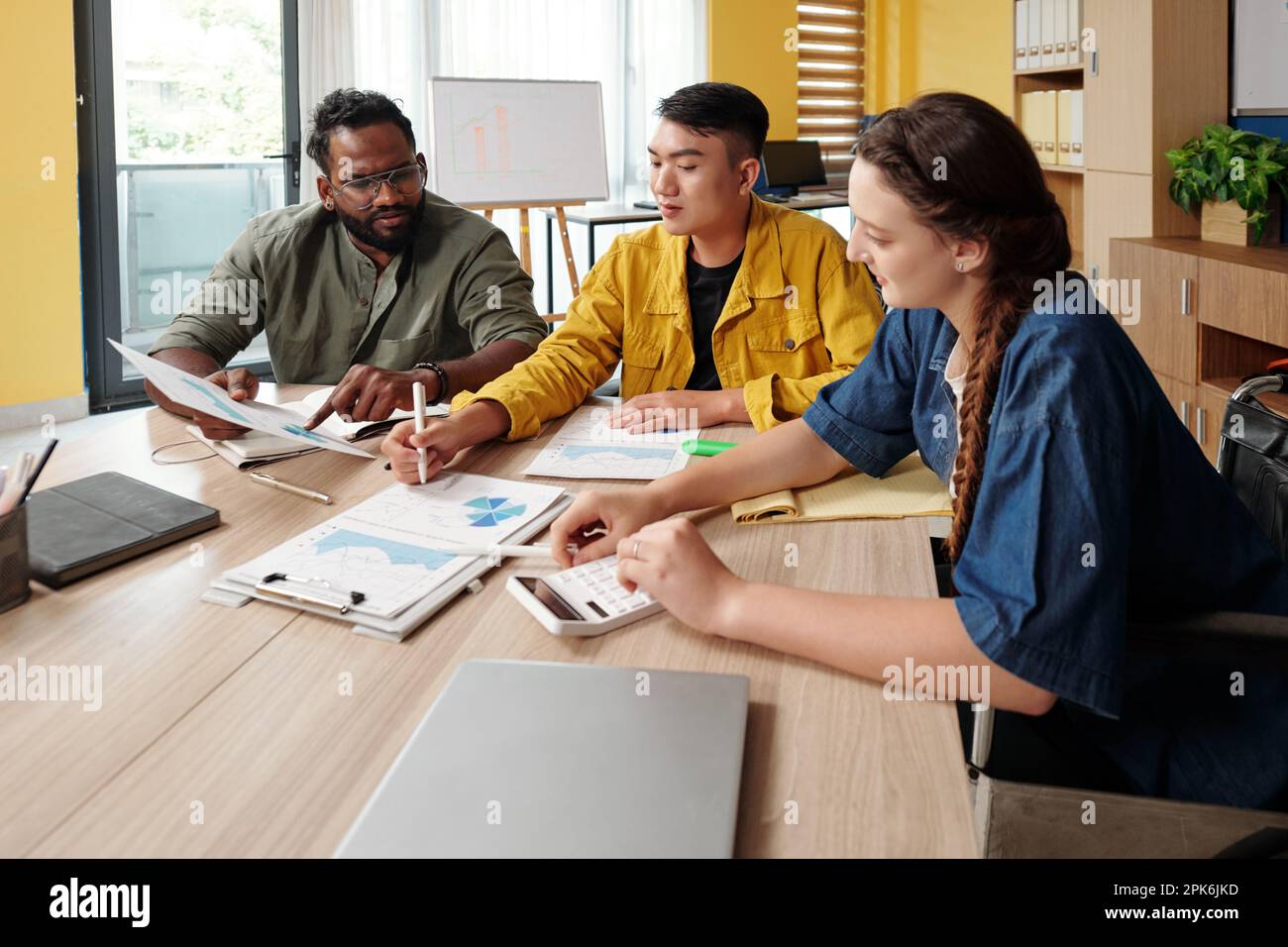 Business team working with reports, analyzing financial data Stock Photo
