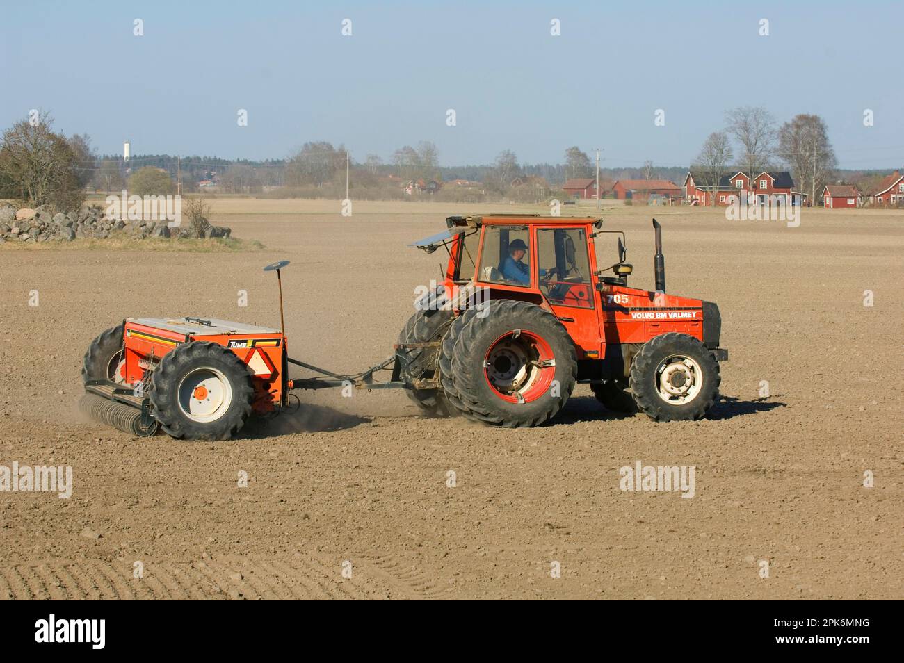 Volvo BM Valmet 705 tractor with pulling Tume HKL-4000 seed drill, seed field, Sweden, spring Stock Photo