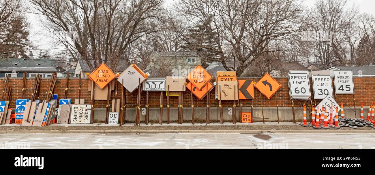 Madison Heights, Michigan, Road signs and barriers for a highway construction project stored along an interstate highway in suburban Detroit Stock Photo