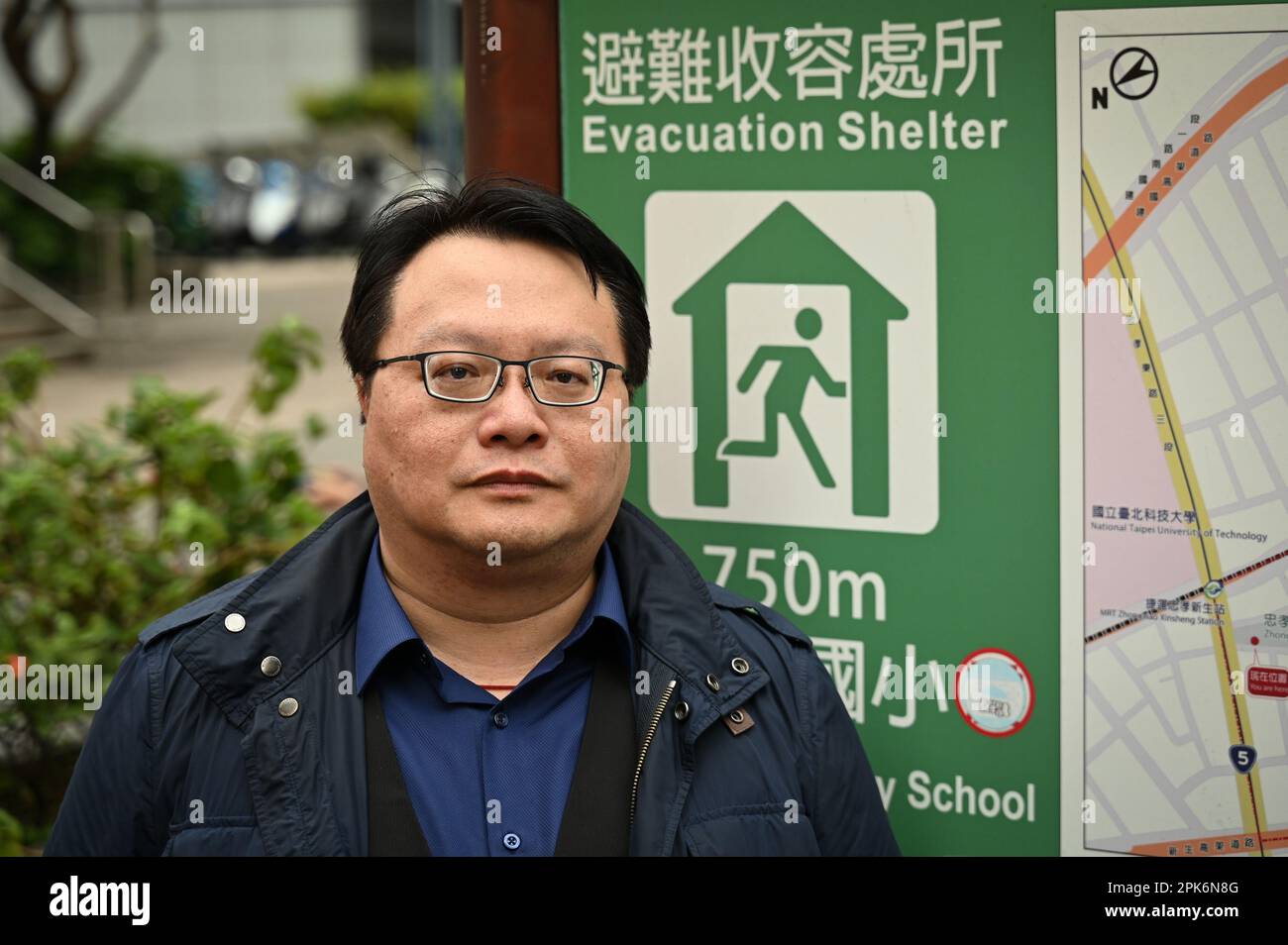 Taipei, Taiwan. 24th Mar, 2023. Kuma Academy co-founder Ho Cheng-hui stands near an evacuation shelter sign in Taipei, Taiwan on March 24, 2023. Interest in training has grown in civil defense training over the last year in the wake of ongoing threats from China and Russia's invasion of Ukraine. Photo by Thomas Maresca/UPI Credit: UPI/Alamy Live News Stock Photo