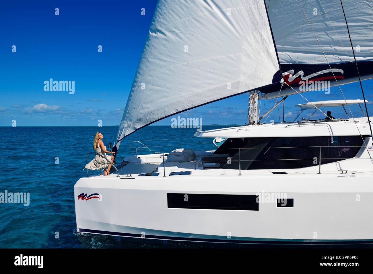Woman enjoying the ride on a sailing catamaran, Exuma Cays, Bahamas Stock Photo Alamy
