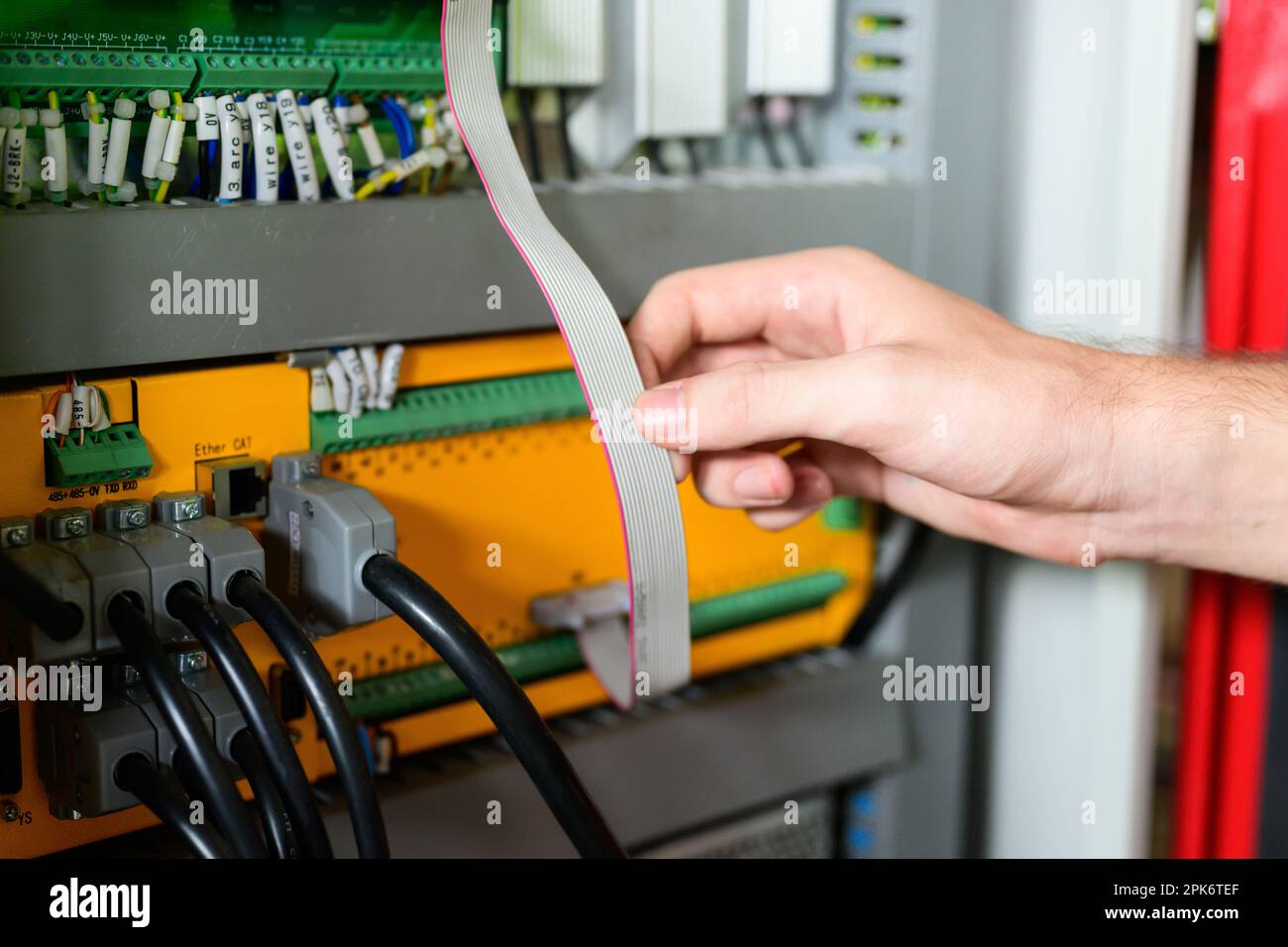 Technician engineer holding robot controller checking and repairing machine Stock Photo