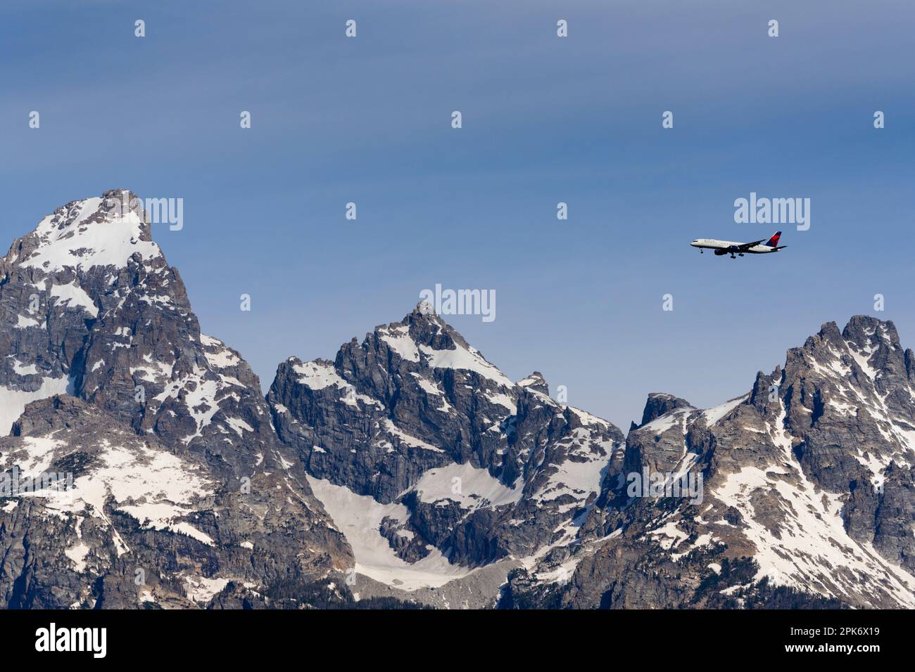 Mountains covered in snow, plane in sky, Wedge Mountain, British Columbia, Canada Stock Photo