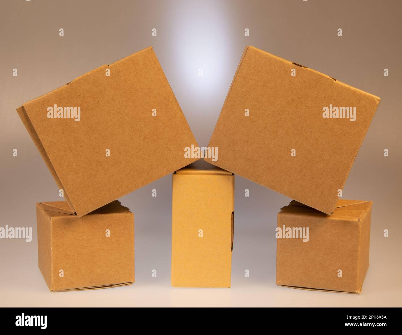 Little brown boxes in various formations on my light table Stock Photo