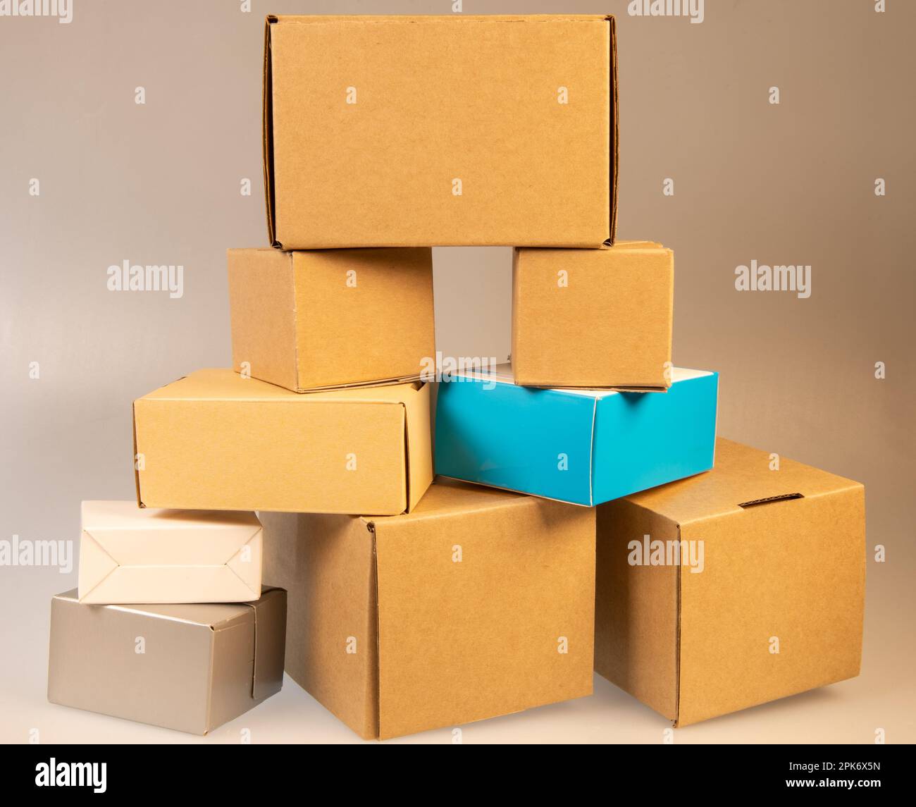Little brown boxes in various formations on my light table Stock Photo