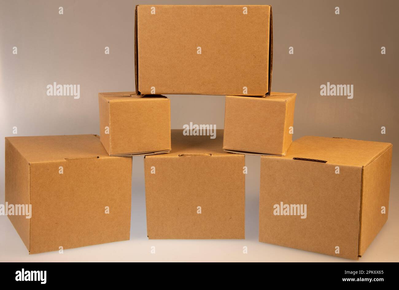 Little brown boxes in various formations on my light table Stock Photo