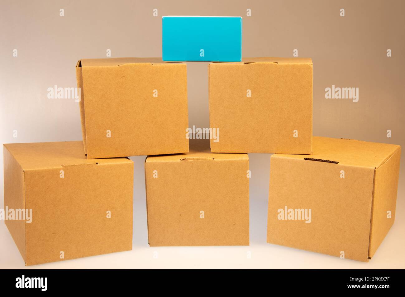 Little brown boxes in various formations on my light table Stock Photo