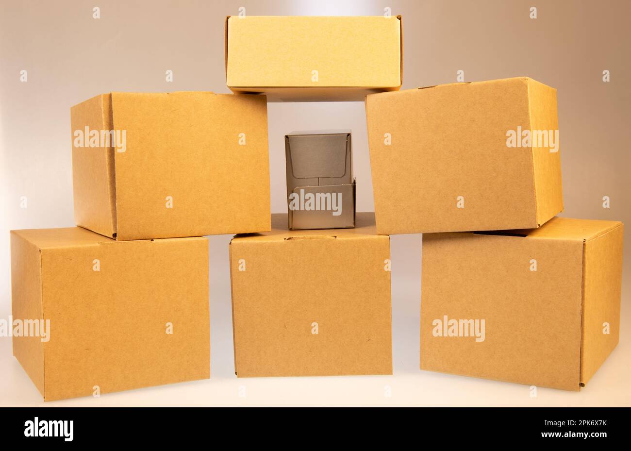 Little brown boxes in various formations on my light table Stock Photo