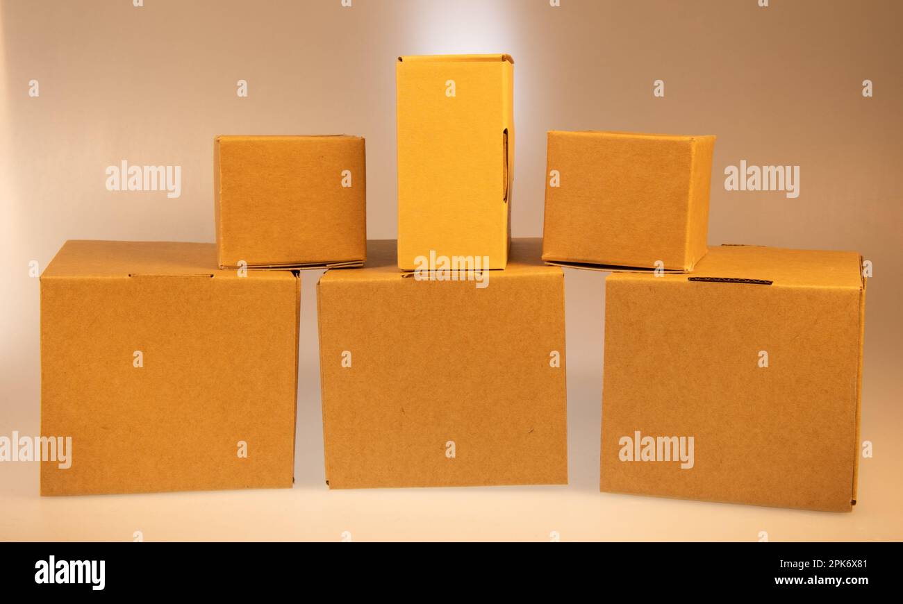 Little brown boxes in various formations on my light table Stock Photo