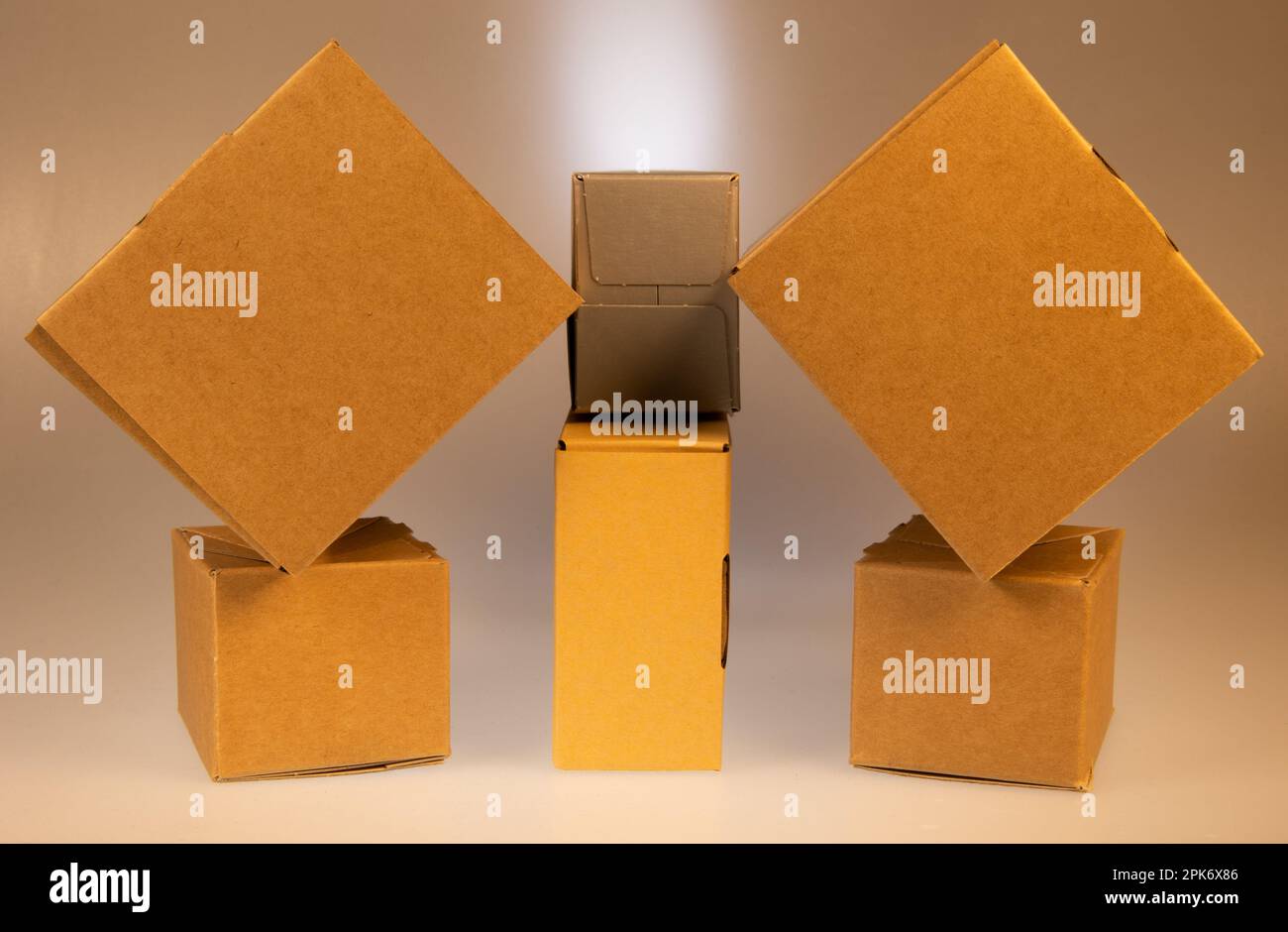 Little brown boxes in various formations on my light table Stock Photo