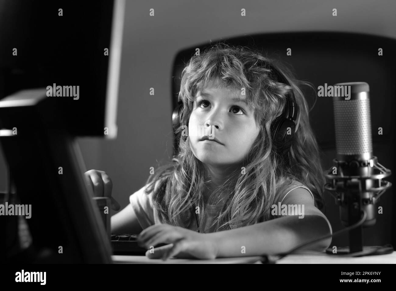 Kid using pc at night. Child with computer in a dark room. School
