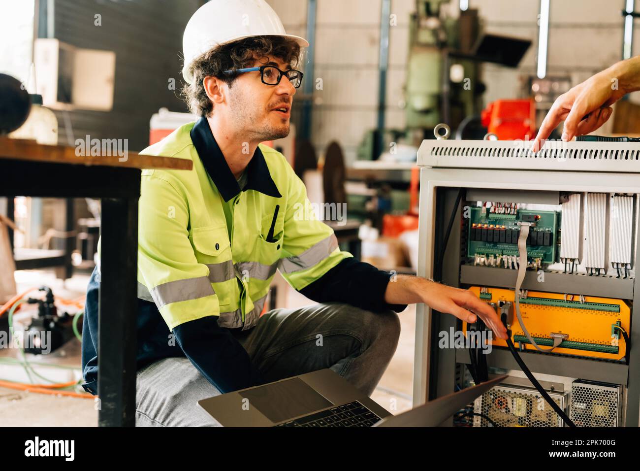 Engineer Reparing Machine Technician engineer checking and repairing automatic robotic machine ...