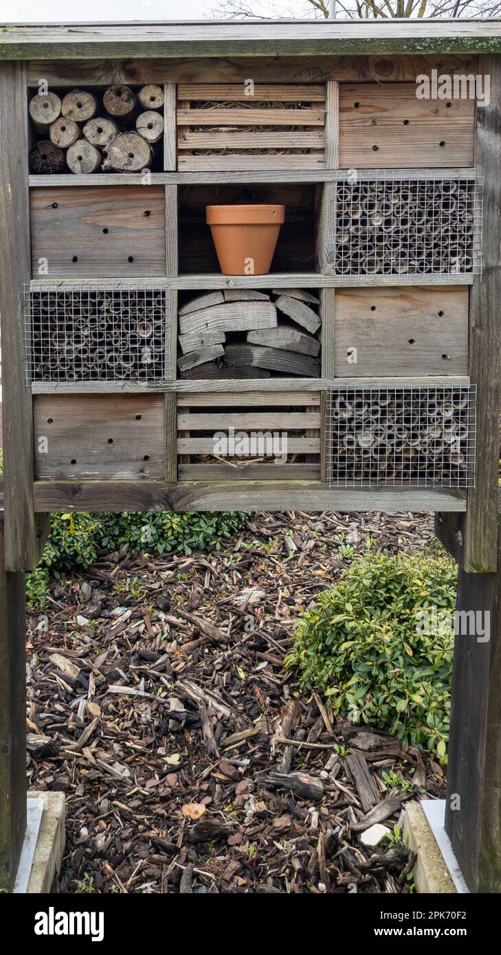 hut bug hotel insect house wooden give protection and nesting aid to bees and insects outdoor Stock Photo