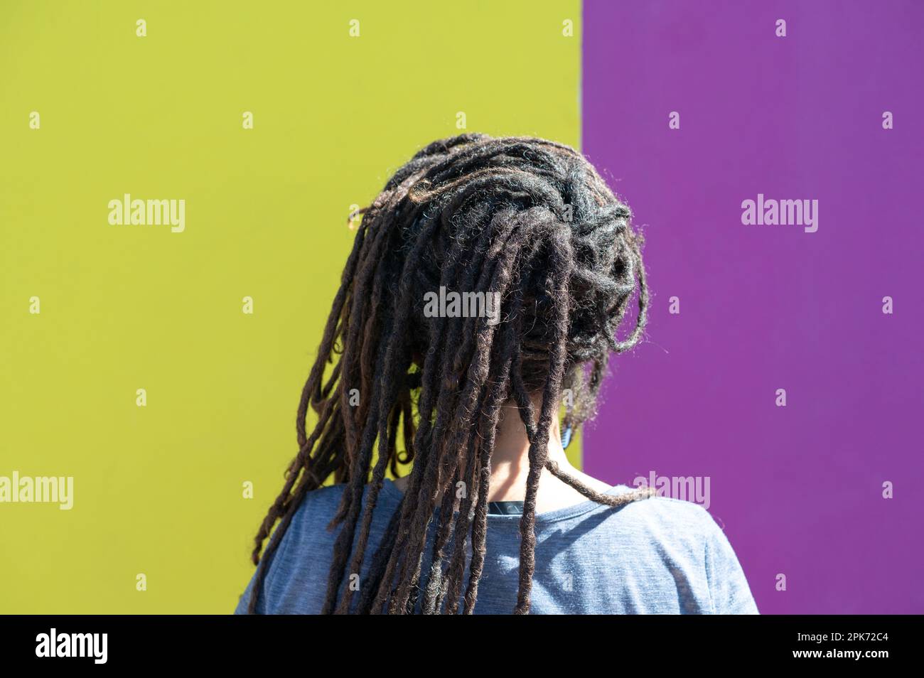Dramatic portrait of young female with horror black stage makeup painted on  face and orange color dreadlocks hairstyle. Studio shot on blue background  Stock Photo - Alamy