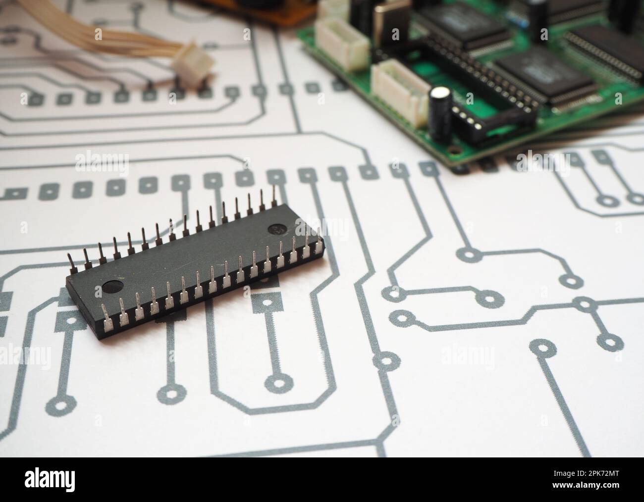 32 pins integrated circuit on the electronic diagram. Printed circuit board background. Stock Photo