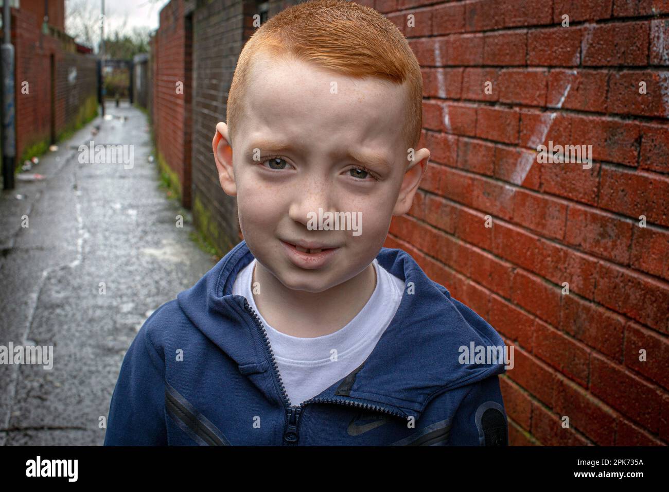 NORTHERN IRELAND  - A young boy with ginger hair in West Belfast , Northern Ireland. Stock Photo