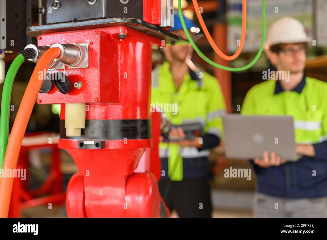 Two technicians workers with safety uniform using laptop talking Stock Photo