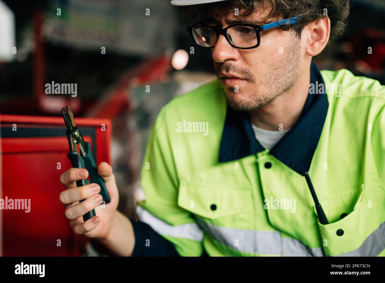 Technician engineer holding robot controller checking and repairing machine Stock Photo