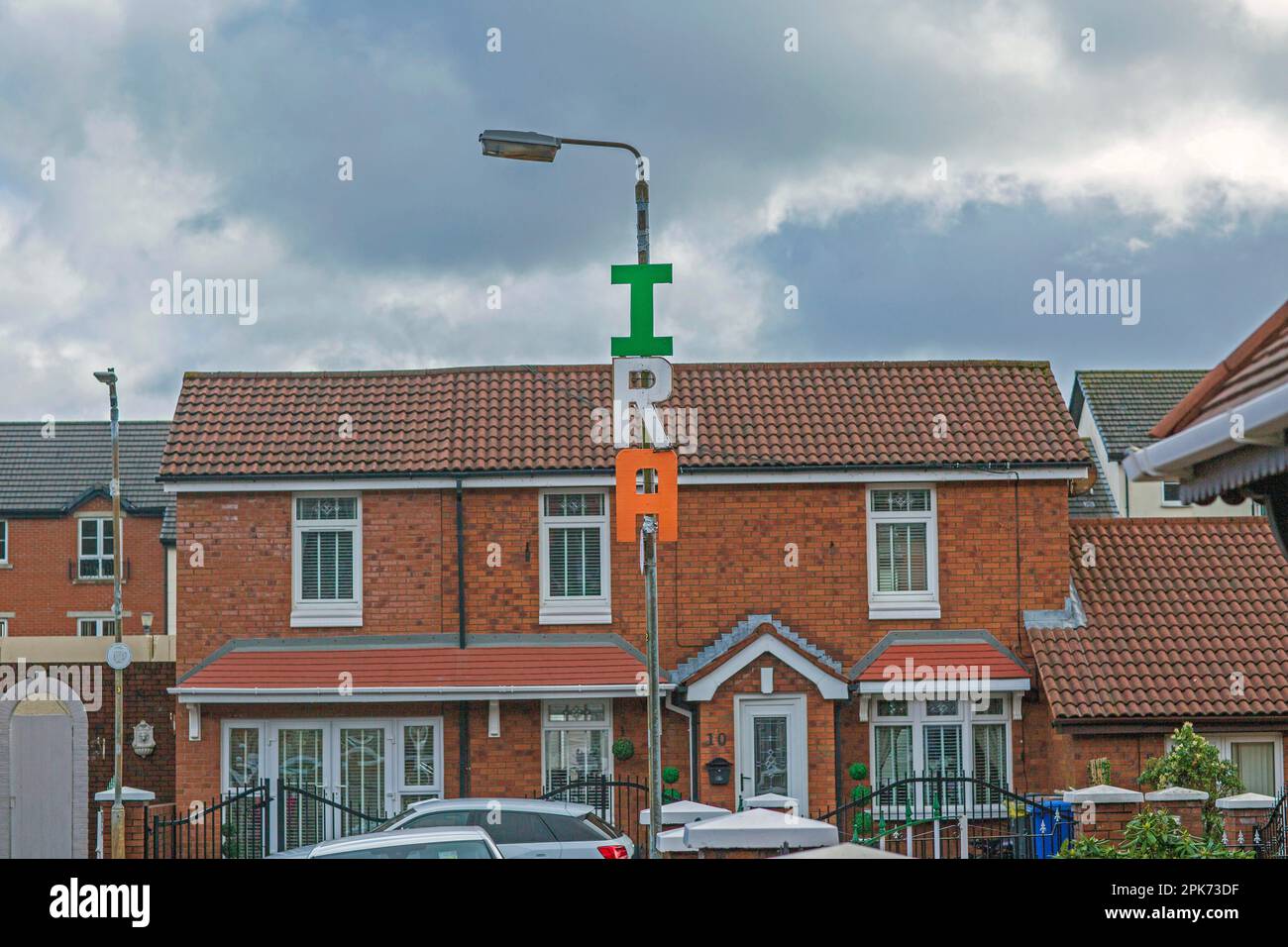 Letters Spelling I.R.A. is seen on display high on a lamp post in west Belfast  , Northern Ireland . Stock Photo