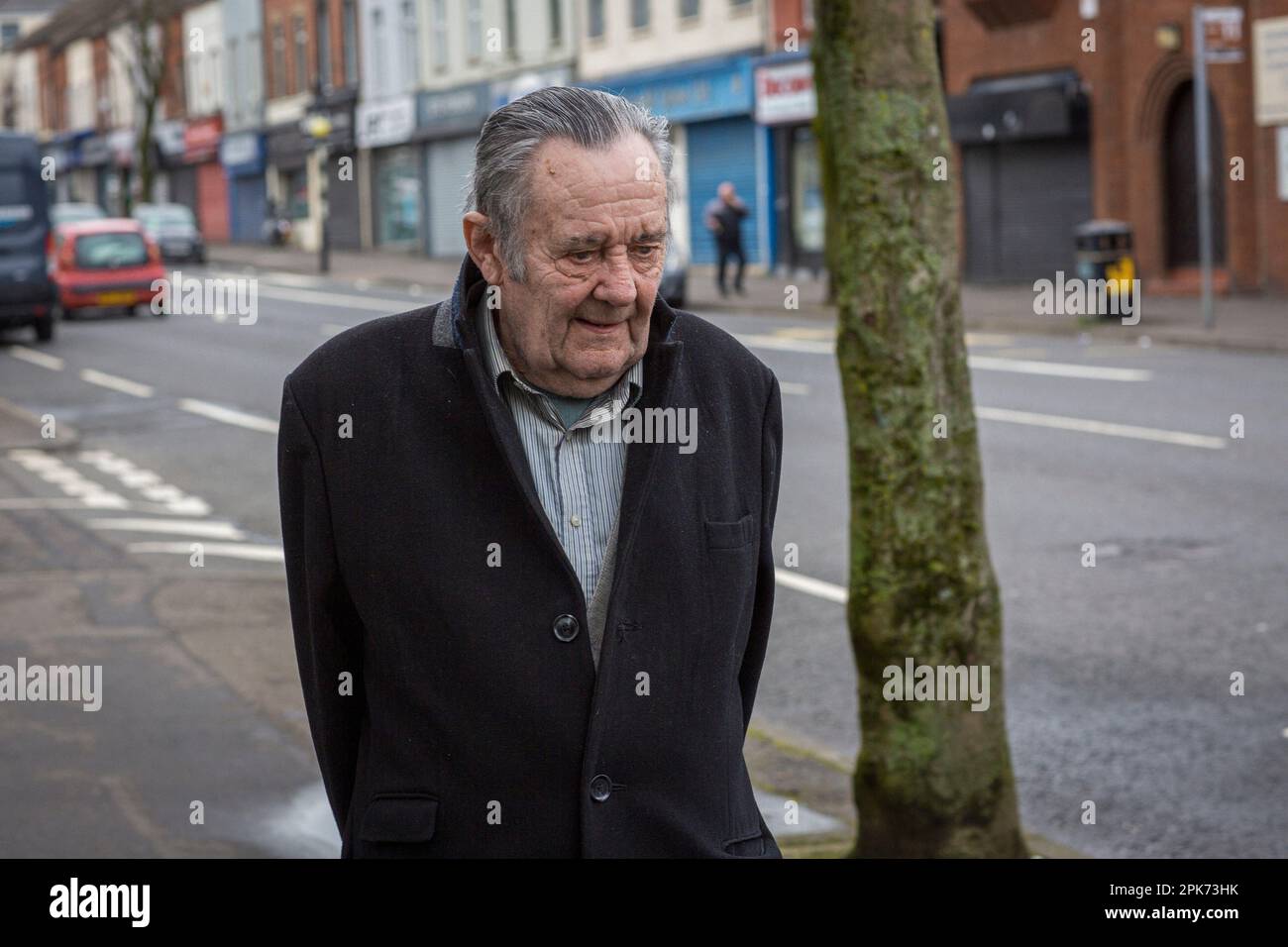 Old man walking down Shankill Road in Belfast, County Antrim, Northern Ireland, UK Stock Photo