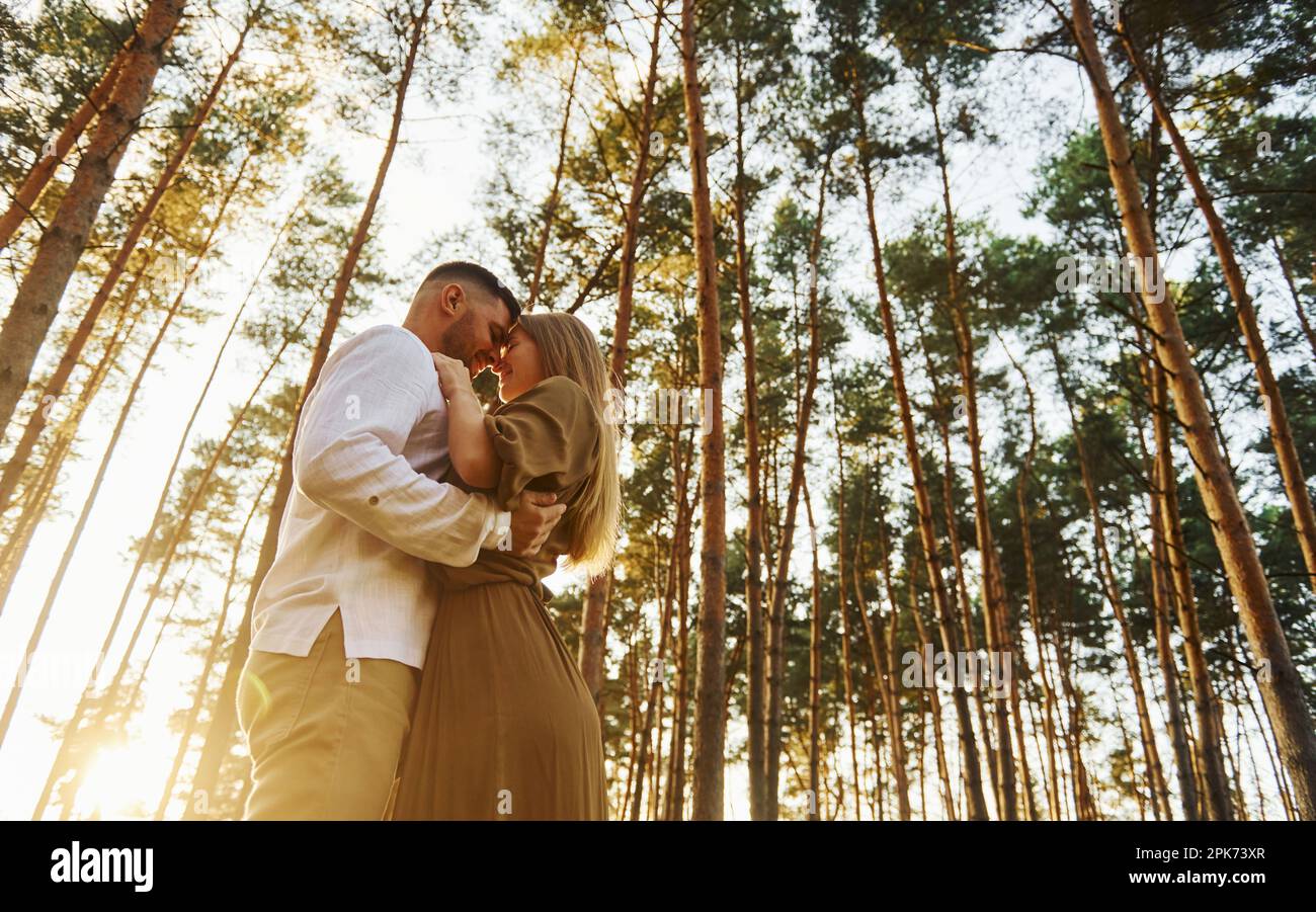 In the forest at daytime. Happy couple is outdoors Stock Photo - Alamy
