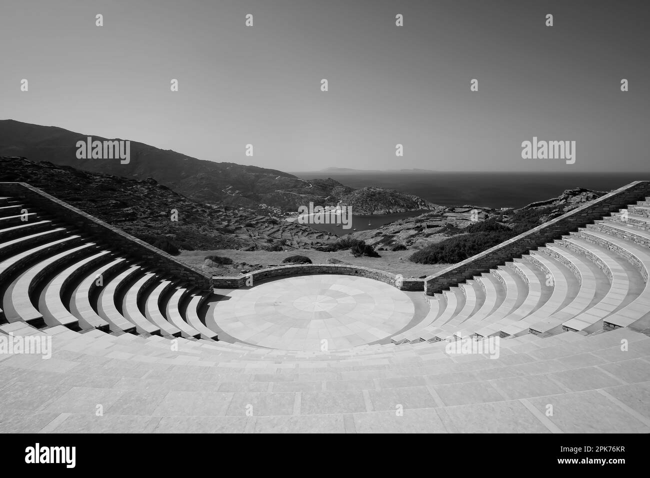 View of the Odysseas Elytis outdoor theatre and the famous Mylopotas beach in the background in Ios Greece in black and white Stock Photo