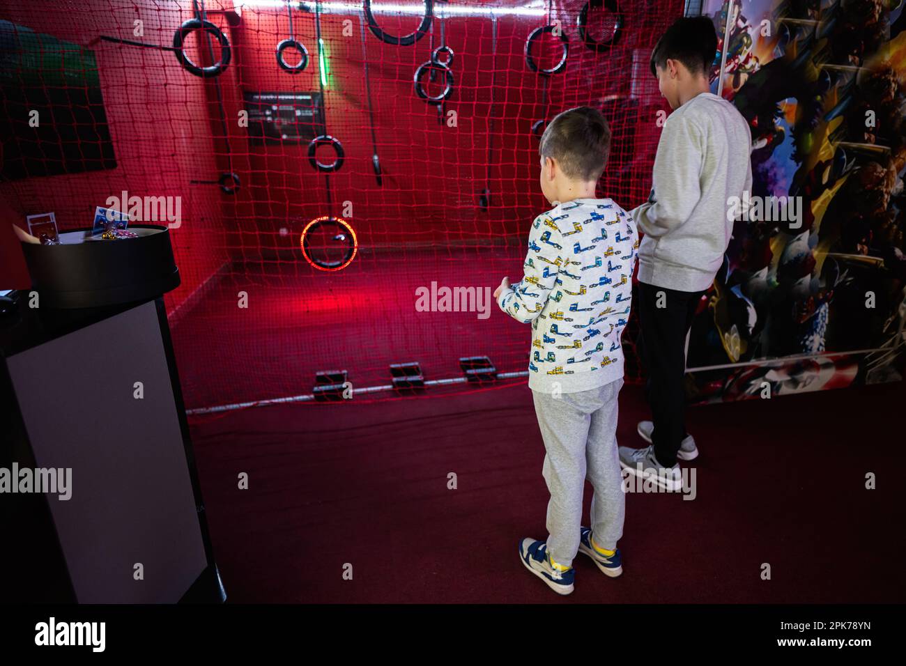 Children flying remote control drones game indoor play zone Stock Photo