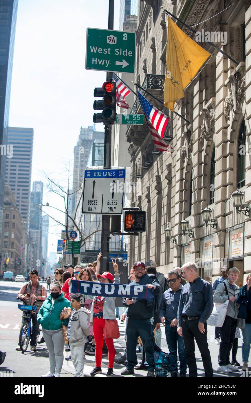Pro President Trump family holding a Trump sign and getting reactions on busy 55th St and 5th Ave NYC.  Morning of Trump arraignment, 04 April 2023. Stock Photo