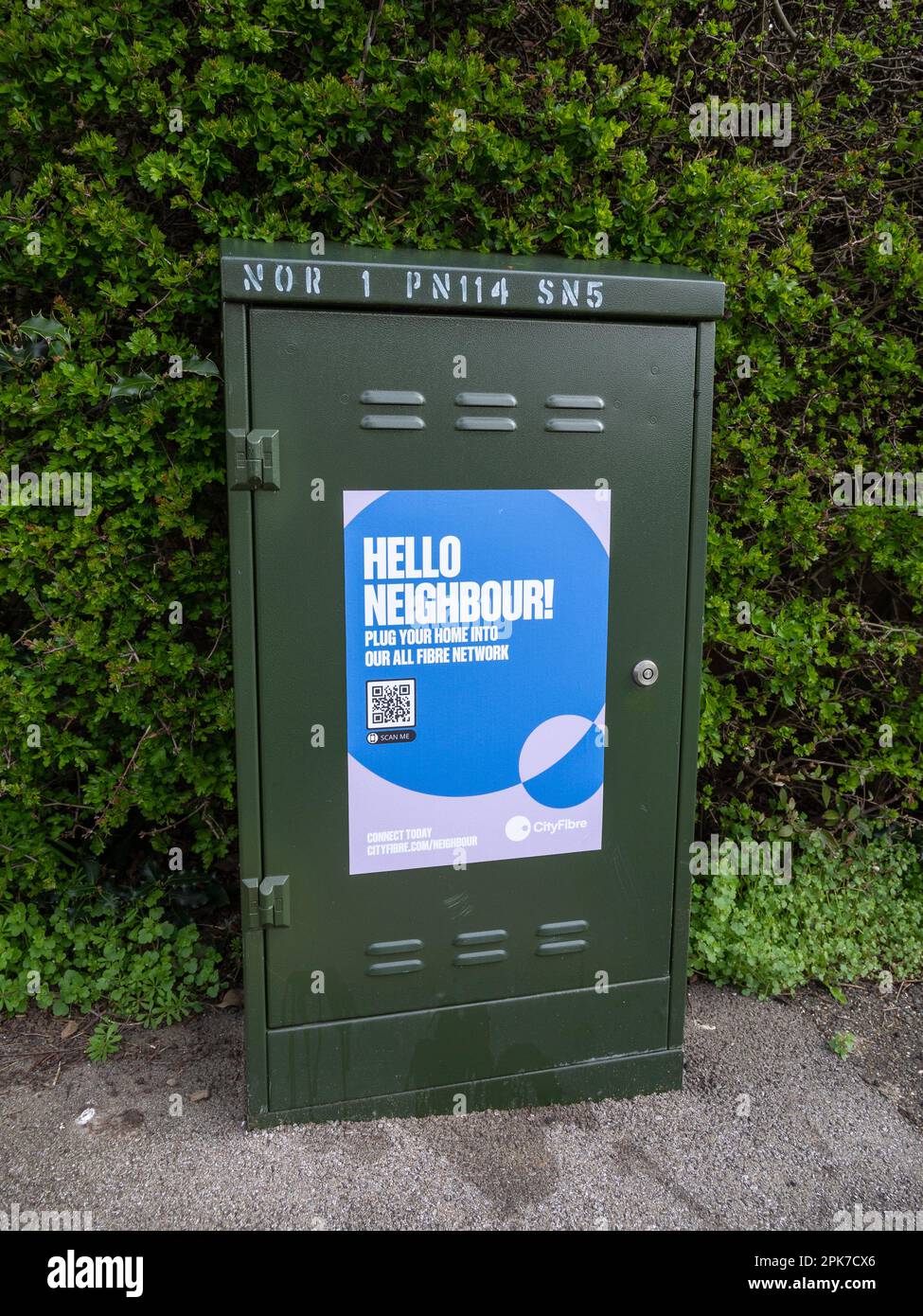 City Fibre broadband engineer's junction box on a suburban street, Wootton, Northampton, UK; with Hello Neighbour slogan Stock Photo