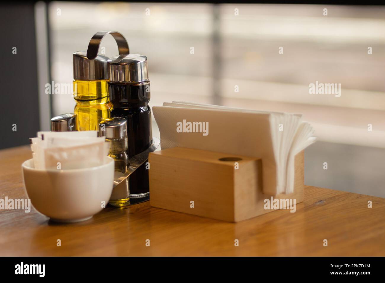 Table served for dinner. Olive oil and vinegar and napkin holder. Table