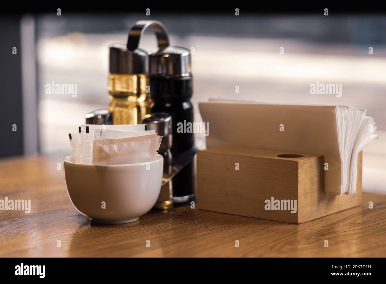 Table served for dinner. Olive oil and vinegar and napkin holder. Table