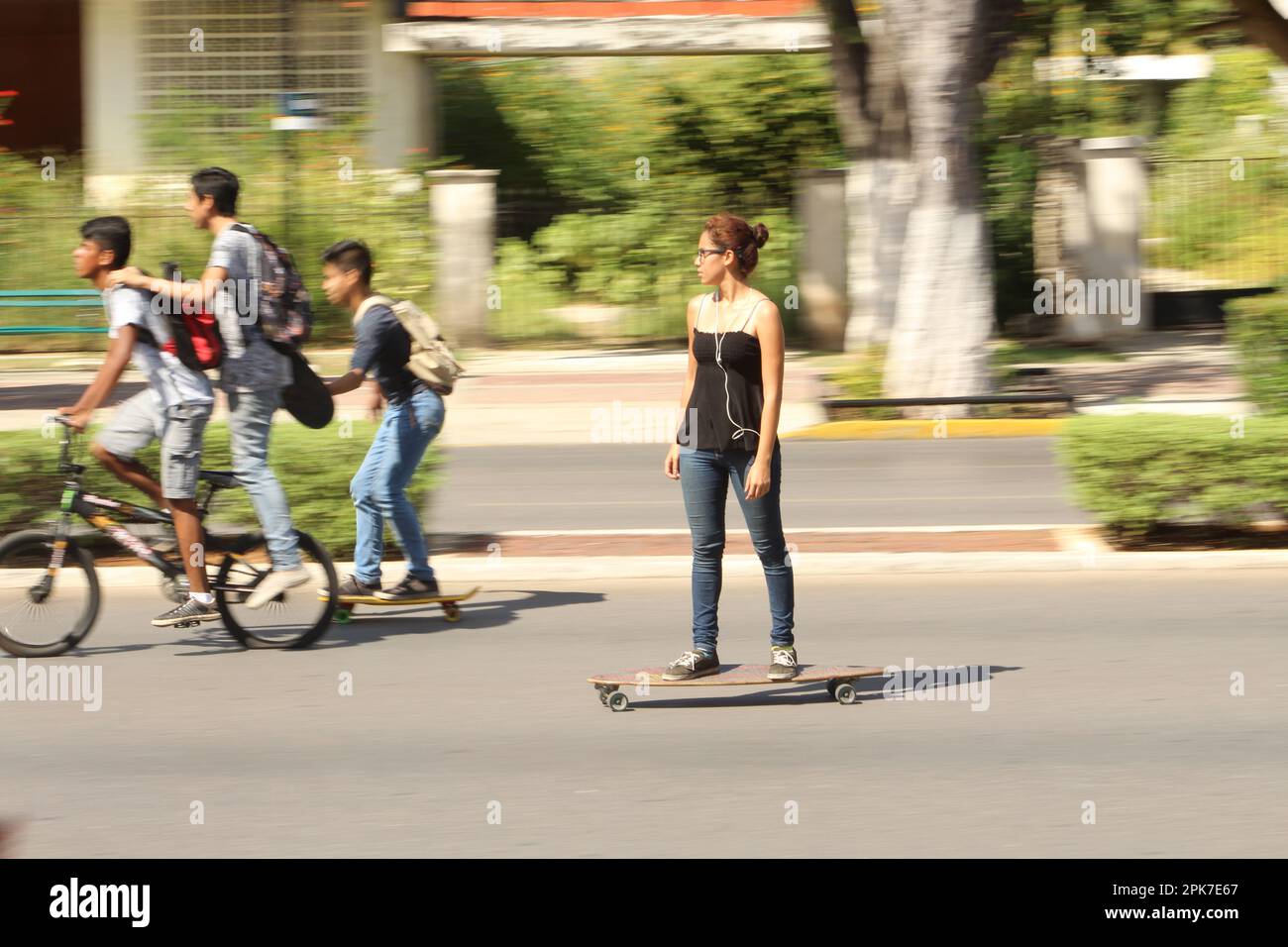 MERIDA, MEXICO - OCTOBER 23, 2016 Sunday cycling on the  Paseo de Montejo - girl on a skateboard Stock Photo