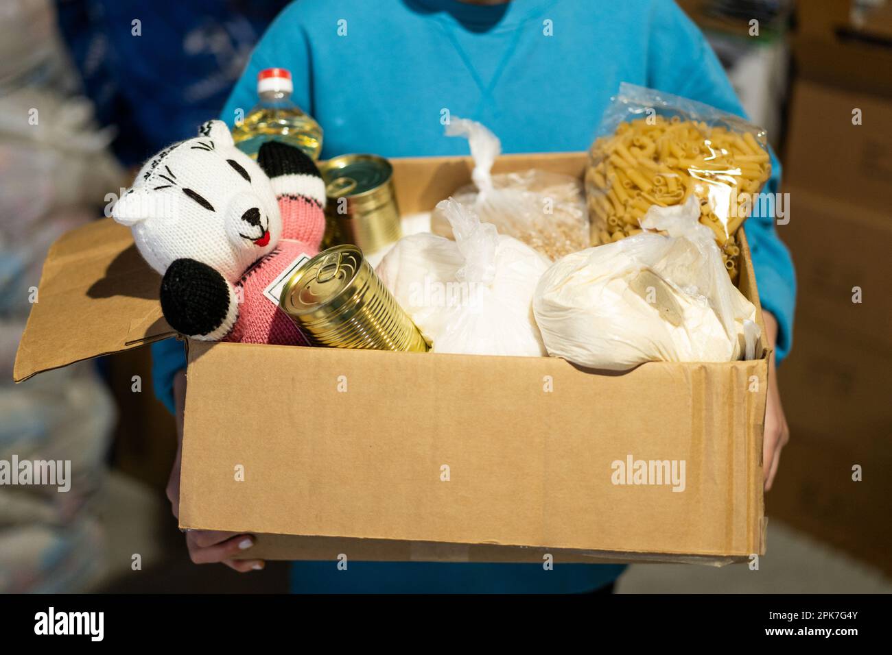 Volunteer girl preparing donation boxes for people. Donation clothing