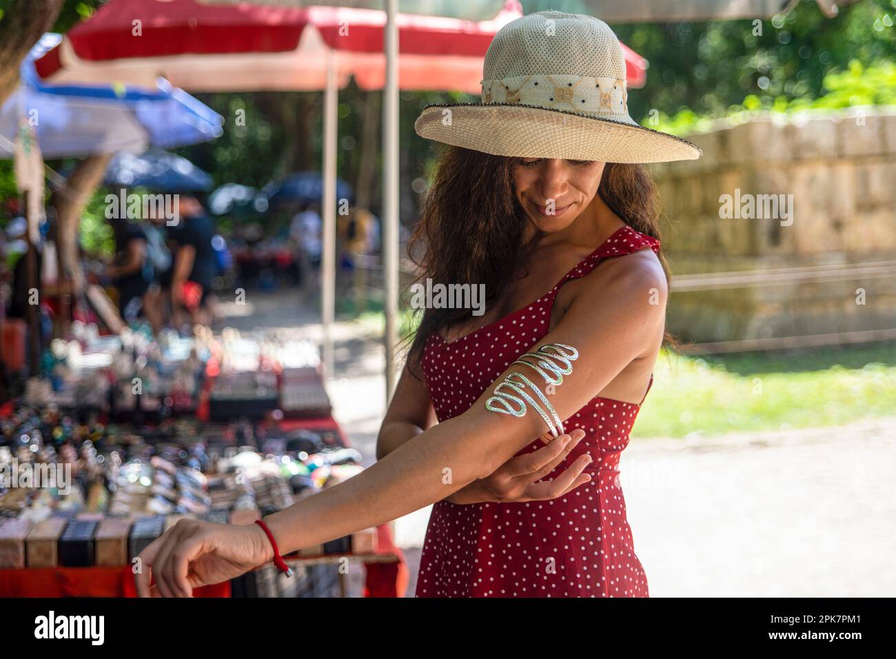 Tourist buying a costume jewelry bracelet and souvenirs at a street