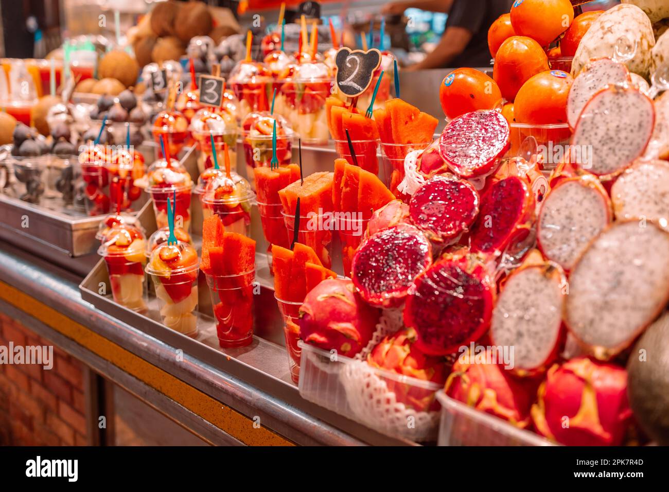 Assortment of fresh cut fruit in plastic containers in market grocery display case, Barcelona