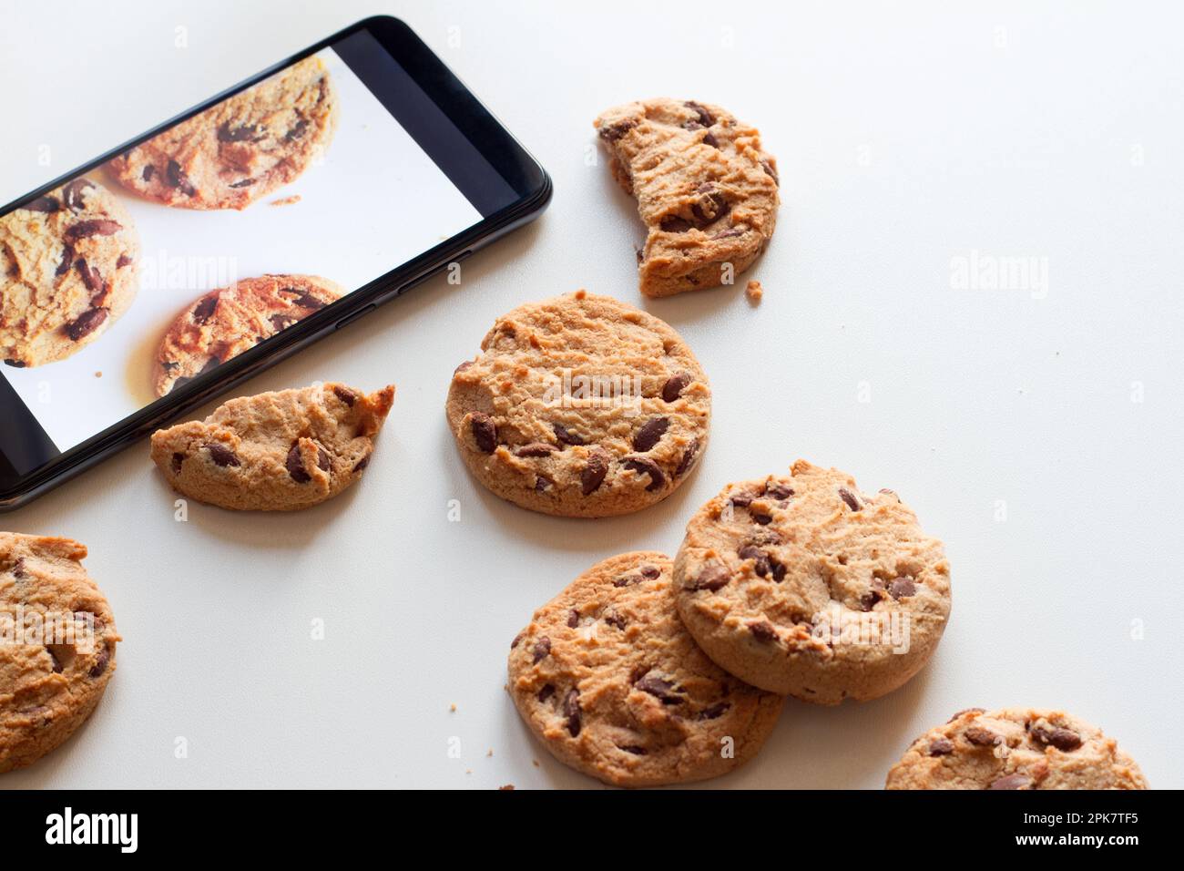 Pop-up cookies from smartphone concept Stock Photo