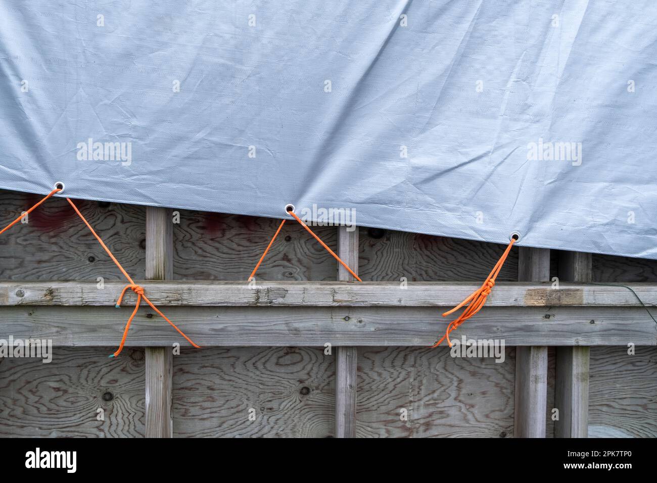 A tarpaulin tied to a wooden crate Stock Photo