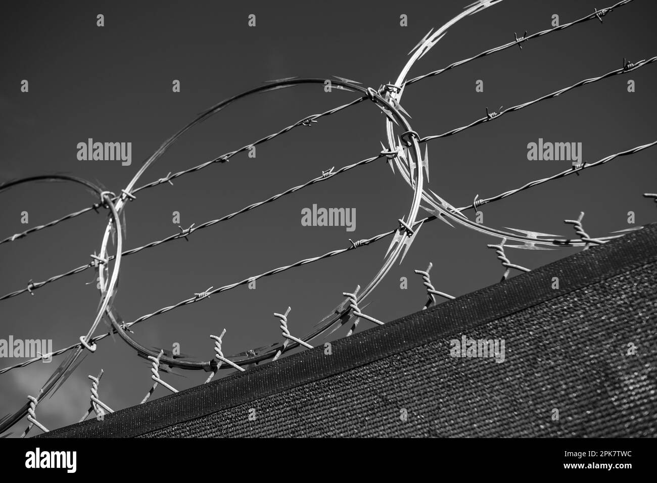 A barbed wire fence and draped frabric. Stock Photo