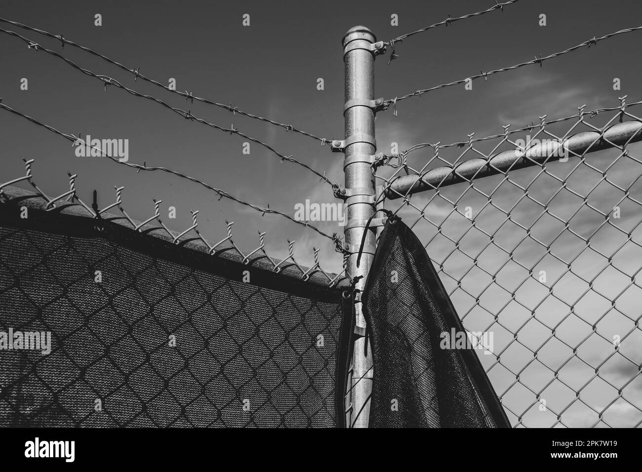 Stock photo of barbed wire fence and draped fabric. Stock Photo