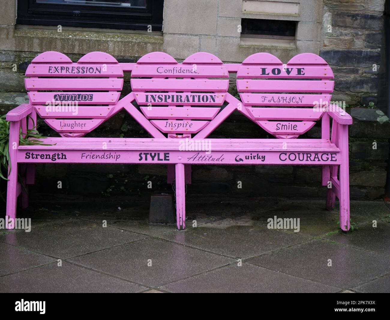 Pink bench with inspirational sayings in Looe, Cornwall Stock Photo