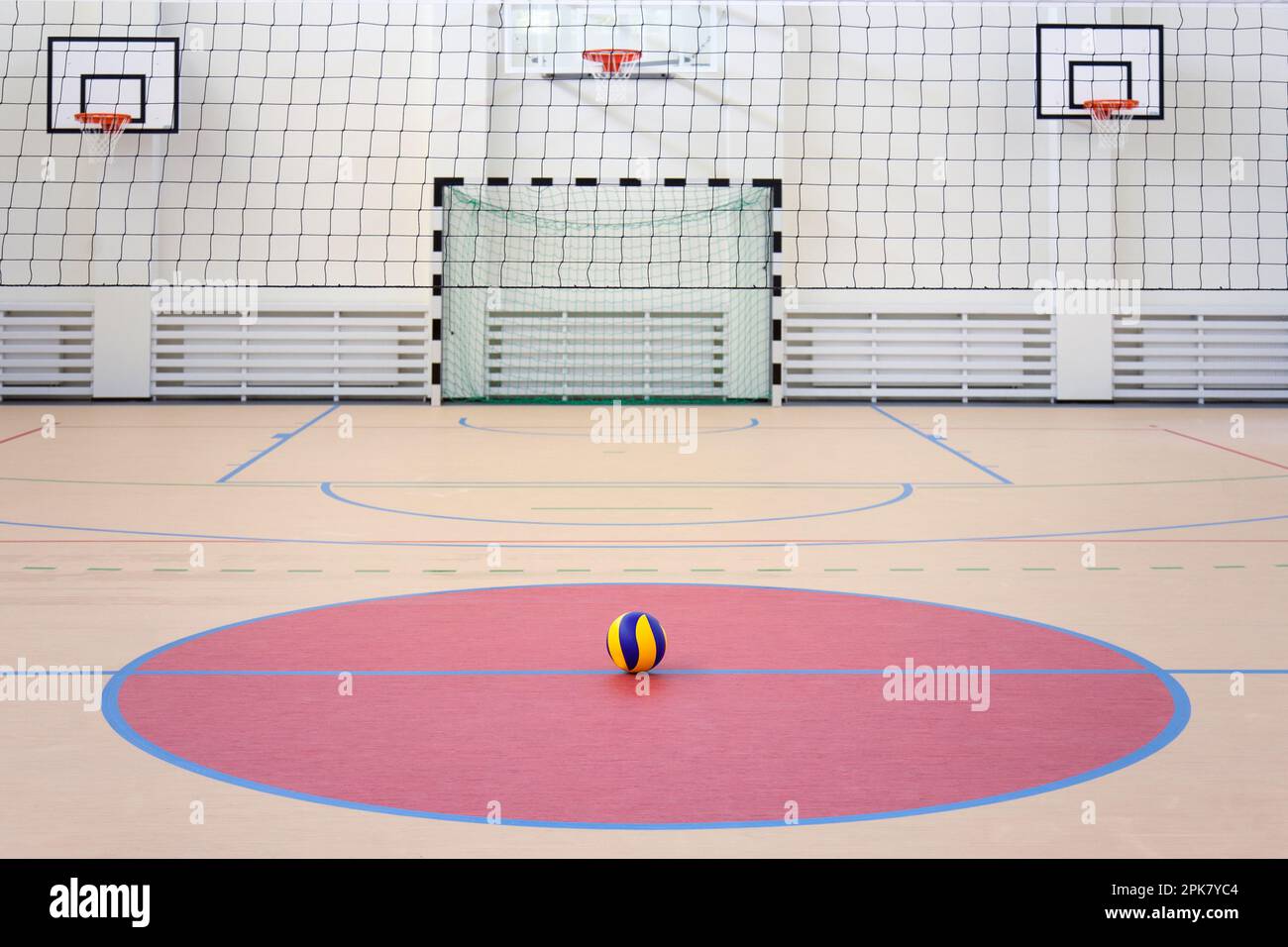 A school sports hall with a marked indoor football pitch, goal and