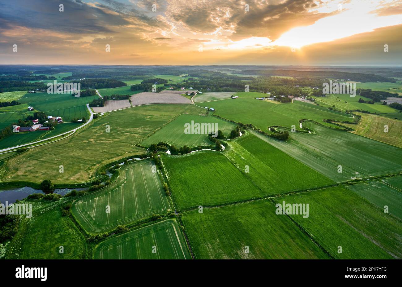 An aerial view of a rural landscape featuring a river snaking through ...