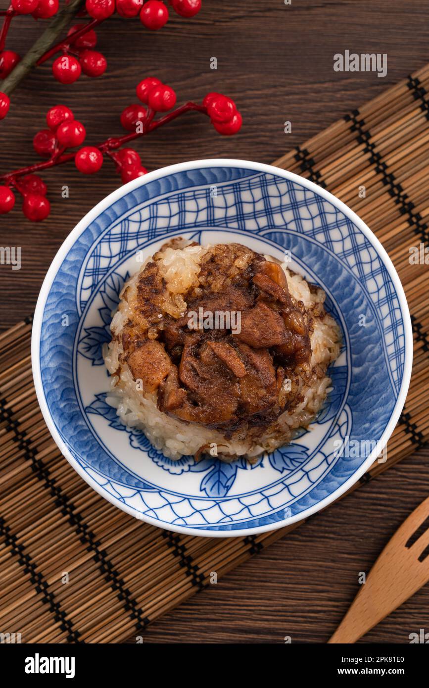 Migao, tube rice cake, rice pudding in a bowl topped with minced pork, delicious Taiwanese street food. Stock Photo