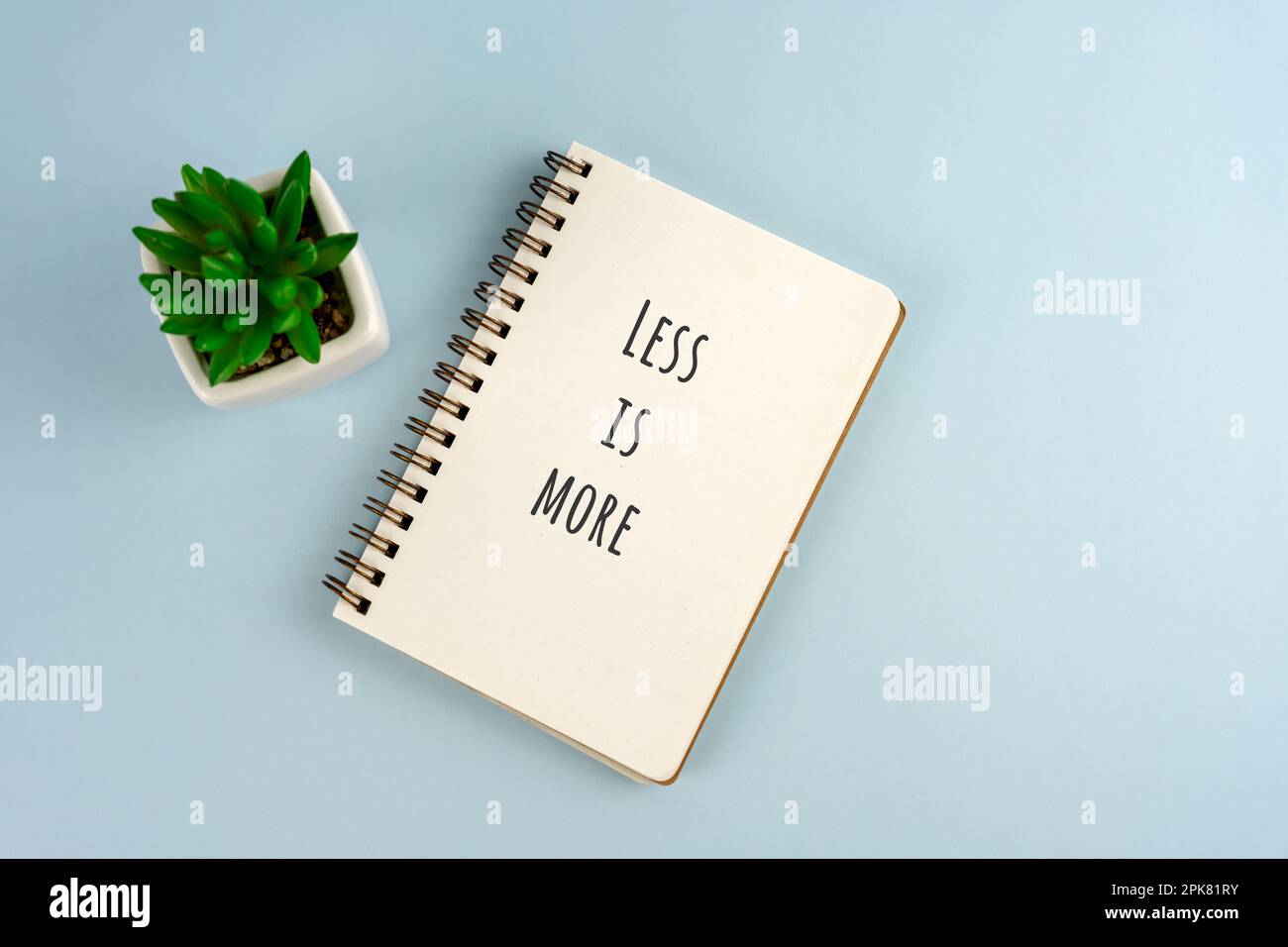 Less me more inspirational quotes text on notepad Stock Photo