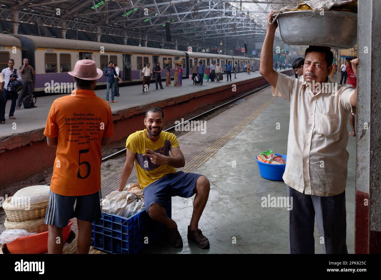 Small-time fish vendors at Chhatrapati Shivaji Maharaj Terminus in Mumbai, India, waiting for a local train to forward their purchases of fish Stock Photo