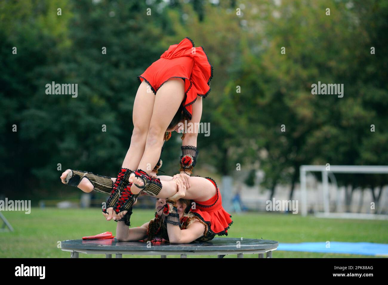 Group of little girls acrobats doing acrobatic tricks on a football field. Opening the University of physical culture and sport. June 20, 2019. Kyiv, Stock Photo