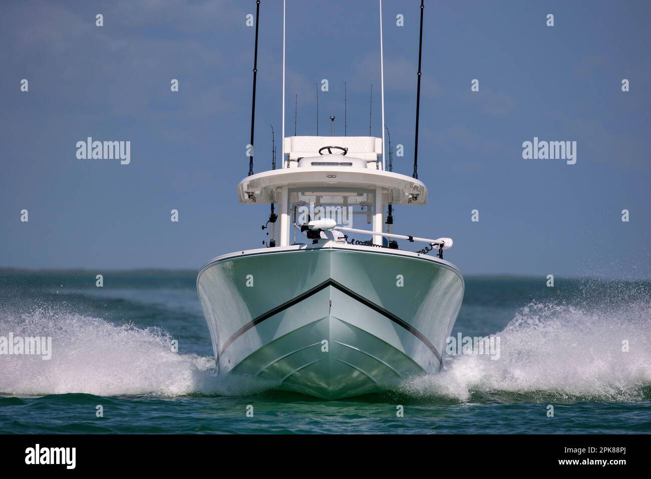 A center console fishing boat approaching headon at high speed Stock