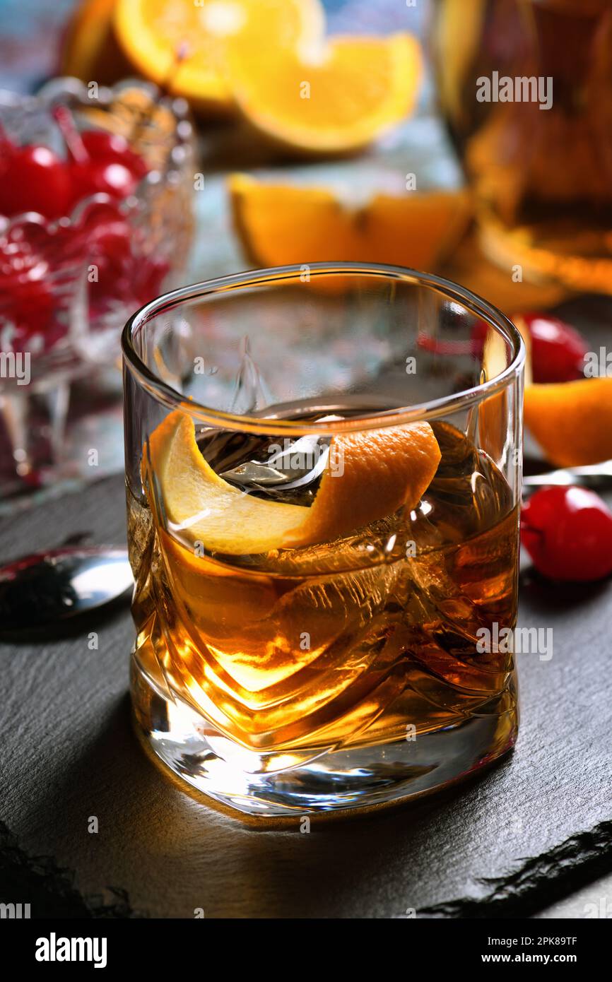 The Irish redhead. Whiskey cocktail, grenadine syrup, club soda, lemon or lime juice, garnished with   orange zest, served in scotch class with ice. Stock Photo