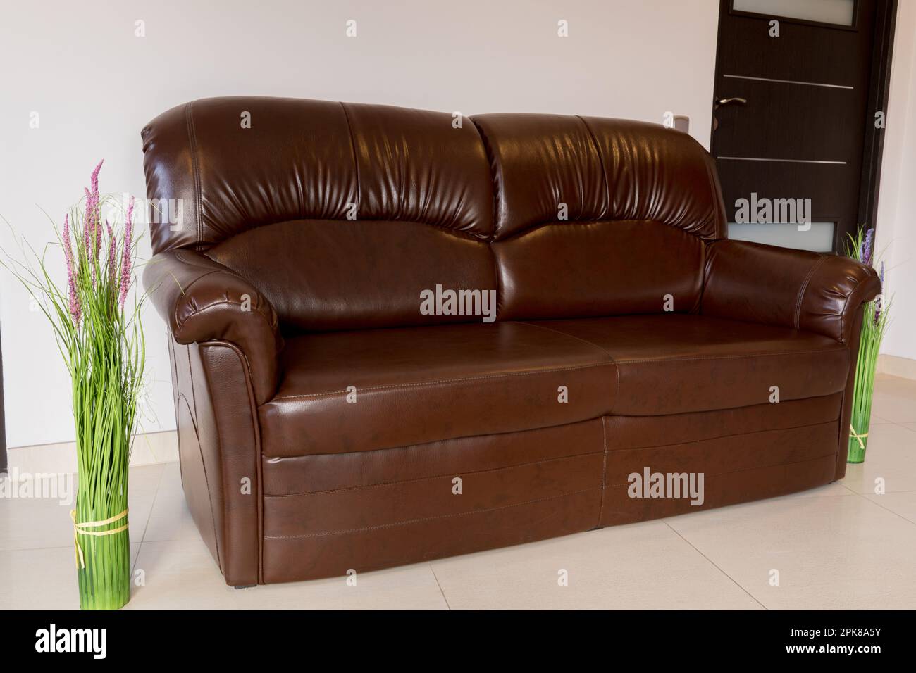 Leather brown sofa in the living room Stock Photo - Alamy