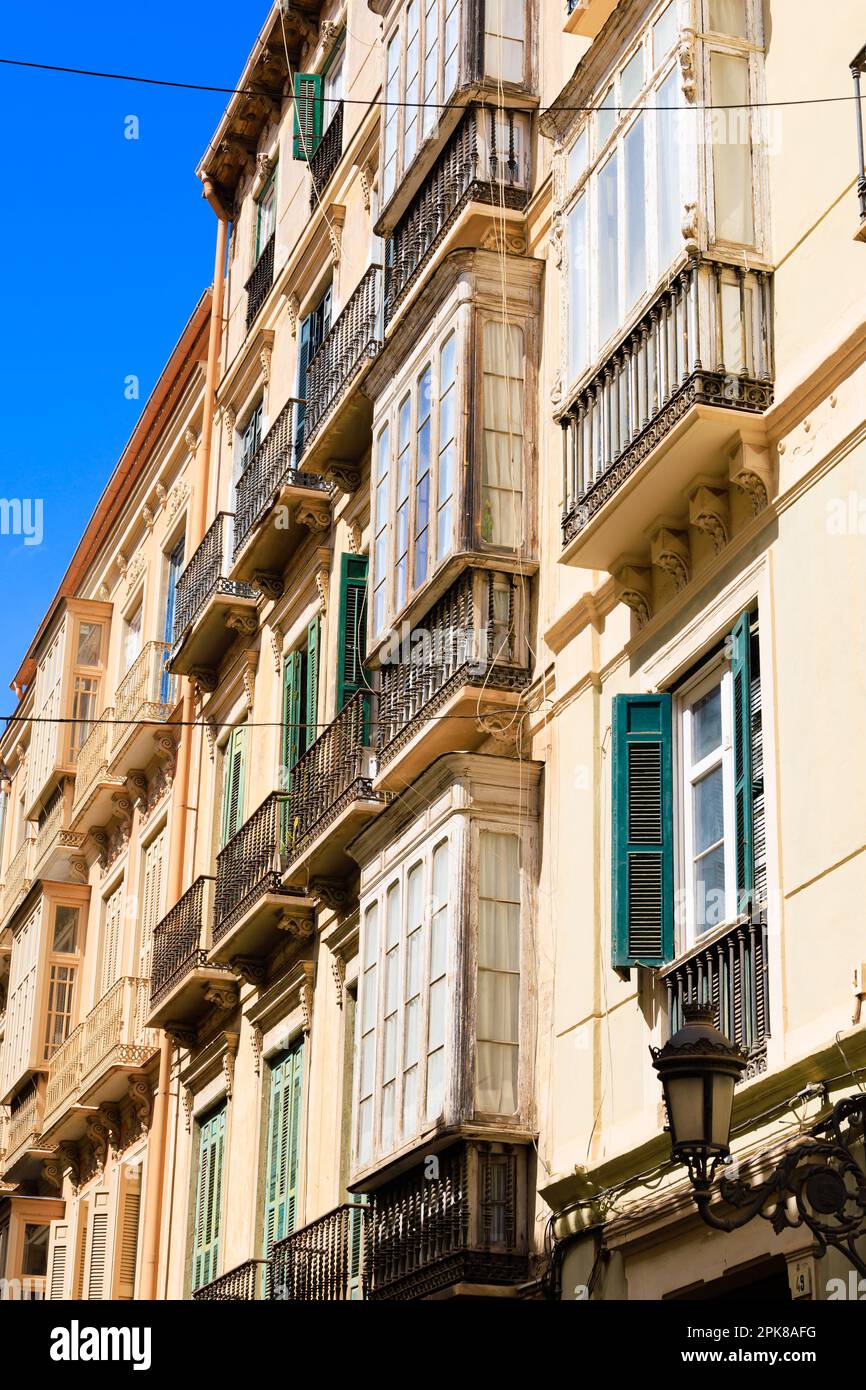 Shuttered windows and balconies above the city streets of Malaga